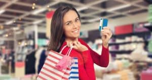 Women carrying small bags and holding a credit card